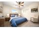 Comfortable main bedroom with a king-size bed and armchair at 1113 Oakland Cir, Tavares, FL 32778