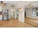 Open concept living area with wood flooring and kitchen view at 1113 Oakland Cir, Tavares, FL 32778