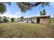 Backyard view, showing home exterior and shed at 1113 Oakland Cir, Tavares, FL 32778