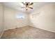 Simple bedroom with ceiling fan, carpet flooring, and built-in shelving at 1113 Oakland Cir, Tavares, FL 32778