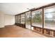 Spacious sunroom with ample natural light and wood-paneled walls at 1113 Oakland Cir, Tavares, FL 32778
