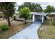 House exterior with a driveway and landscaping at 1113 Oakland Cir, Tavares, FL 32778