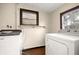 Laundry room with washer and dryer, and overhead shelving at 1113 Oakland Cir, Tavares, FL 32778