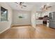 Open living and kitchen area with wood flooring and ceiling fans at 1113 Oakland Cir, Tavares, FL 32778