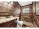 Bathroom with wood-paneled walls, a shower, and a vanity with a sink at 1113 Oakland Cir, Tavares, FL 32778