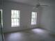 Well-lit bedroom with two large windows at 415 Se 123Rd Street Rd, Ocala, FL 34480
