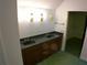 Double vanity bathroom with dark countertop at 415 Se 123Rd Street Rd, Ocala, FL 34480