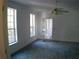Spacious bedroom with large windows and carpeting at 415 Se 123Rd Street Rd, Ocala, FL 34480