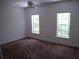 Spacious bedroom with two large windows at 415 Se 123Rd Street Rd, Ocala, FL 34480