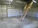 Unfinished workshop with overhead storage and garage door at 415 Se 123Rd Street Rd, Ocala, FL 34480