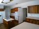 Kitchen features wood cabinets, an island, and a built-in microwave at 415 Se 123Rd Street Rd, Ocala, FL 34480
