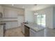 Modern kitchen with white cabinets, granite countertops, and island at 199 Bottle Brush Dr, Haines City, FL 33844