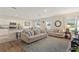 Open living room with neutral furniture and kitchen view at 1163 Haines Dr, Winter Haven, FL 33881