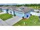 One-story light blue house with gray roof and a two-car garage at 1163 Haines Dr, Winter Haven, FL 33881