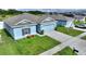 Light blue house with a gray roof, two-car garage, and a small front yard at 1163 Haines Dr, Winter Haven, FL 33881