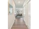 Bright entryway with light wood floors and view to living area at 1163 Haines Dr, Winter Haven, FL 33881