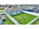 Large backyard with a fenced area, green grass, and a swimming pool at 1163 Haines Dr, Winter Haven, FL 33881