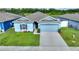 Single story light blue house with gray roof and two-car garage at 1163 Haines Dr, Winter Haven, FL 33881