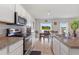 Open concept kitchen with stainless steel appliances and view to dining area at 1163 Haines Dr, Winter Haven, FL 33881