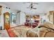 Open living room with views into kitchen and dining areas, featuring comfortable seating at 3914 Scarborough Ct, Clermont, FL 34711