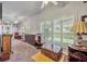 Spacious Gathering room featuring large windows and hardwood floors at 3914 Scarborough Ct, Clermont, FL 34711