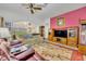 Spacious living room featuring a large TV, comfortable seating, and an inviting atmosphere at 3914 Scarborough Ct, Clermont, FL 34711