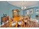Bright dining room with hardwood floors and chandelier at 3914 Scarborough Ct, Clermont, FL 34711