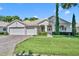 House exterior with double garage and manicured lawn at 3914 Scarborough Ct, Clermont, FL 34711