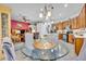 Bright kitchen with granite countertops, wood cabinets, and breakfast nook at 3914 Scarborough Ct, Clermont, FL 34711