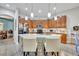 Modern kitchen with granite countertops, ample cabinetry, and an island with seating at 3914 Scarborough Ct, Clermont, FL 34711