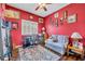 Bright home office features built-in shelving, hardwood floors, and a comfortable seating area at 3914 Scarborough Ct, Clermont, FL 34711