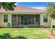 House exterior view with screened porch and backyard at 30732 Lipizzan Ter, Mount Dora, FL 32757