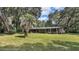 Ranch house with a large yard and trees at 3230 Cr 421, Lake Panasoffkee, FL 33538