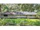 House with a large yard and surrounding trees at 3230 Cr 421, Lake Panasoffkee, FL 33538