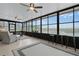 Relaxing screened porch overlooking a lake, with seating and a ceiling fan at 13910 Max Hooks Rd, Clermont, FL 34711
