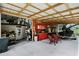 Covered patio area connected to workshop with seating and storage at 13910 Max Hooks Rd, Clermont, FL 34711