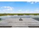 Wooden dock overlooking a calm lake with lush vegetation at 13910 Max Hooks Rd, Clermont, FL 34711