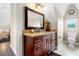 Bathroom with granite countertop and wood cabinets at 13910 Max Hooks Rd, Clermont, FL 34711