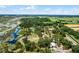 Aerial view of expansive property with multiple buildings and lake at 13910 Max Hooks Rd, Clermont, FL 34711