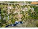 Aerial view of large property with multiple homes and lakefront at 13910 Max Hooks Rd, Clermont, FL 34711