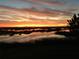 Orange and yellow sunset over water at 13910 Max Hooks Rd, Clermont, FL 34711