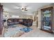 Living area with sectional sofa, area rug, and built-in shelving at 13910 Max Hooks Rd, Clermont, FL 34711