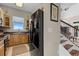 Well-equipped kitchen featuring wood cabinets, granite countertops, and stainless steel appliances at 13910 Max Hooks Rd, Clermont, FL 34711