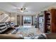 Spacious living room with leather furniture, large TV, and access to a patio at 13910 Max Hooks Rd, Clermont, FL 34711