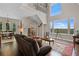 Spacious living room with hardwood floors and large windows offering scenic views at 13910 Max Hooks Rd, Clermont, FL 34711
