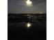 Moonlit marsh with dock at night at 13910 Max Hooks Rd, Clermont, FL 34711