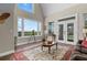 Bright living room with large windows offering scenic views and hardwood floors at 13910 Max Hooks Rd, Clermont, FL 34711
