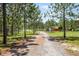 Gravel driveway leading to property with surrounding trees at 13910 Max Hooks Rd, Clermont, FL 34711