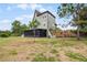 A green house with a screened porch overlooking a grassy landscape at 13910 Max Hooks Rd, Clermont, FL 34711