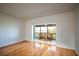 Living room with hardwood floors, balcony access and water views at 601 N Mcdonald St # 608, Mount Dora, FL 32757